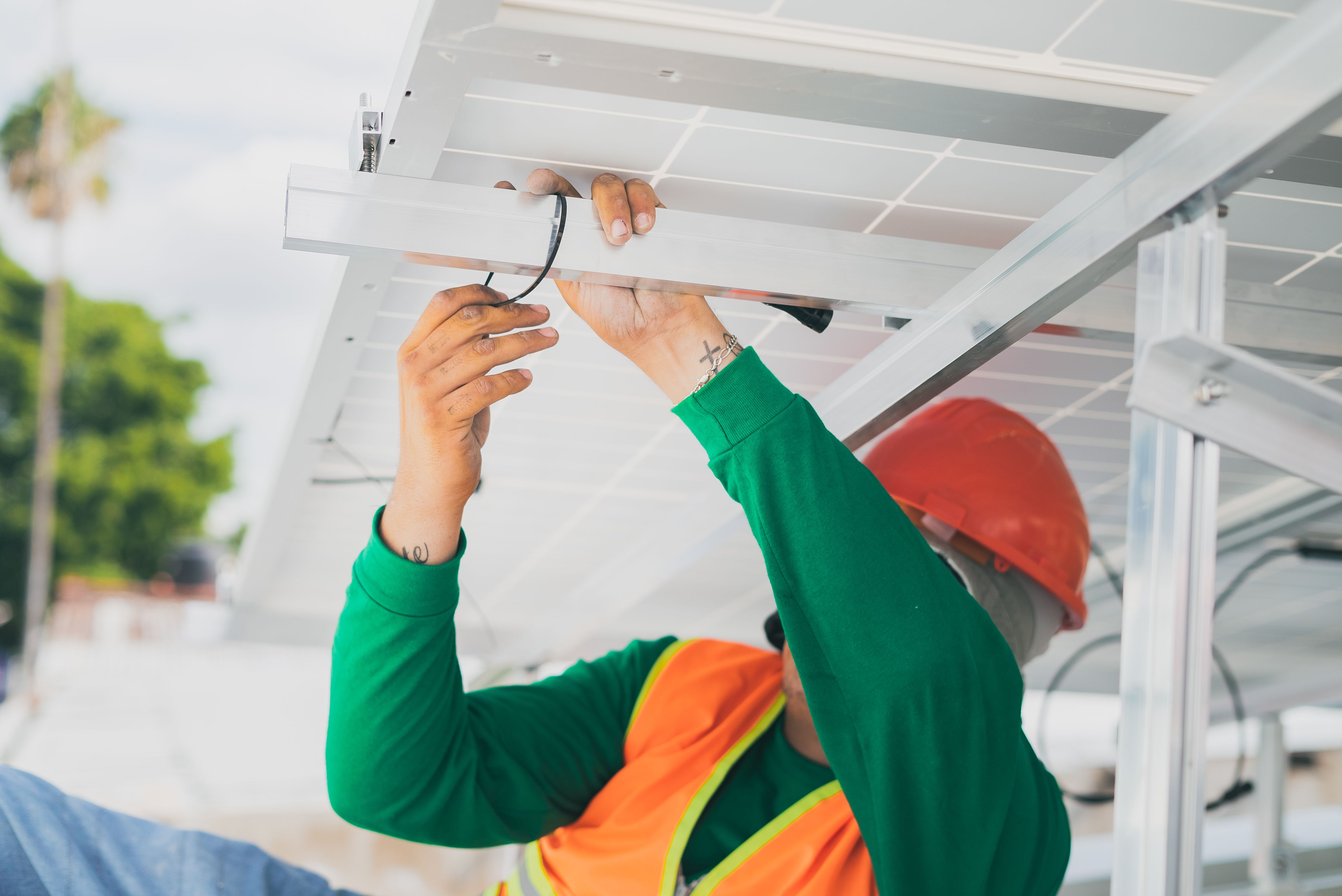 Electrician installing wiring beneath a ceiling