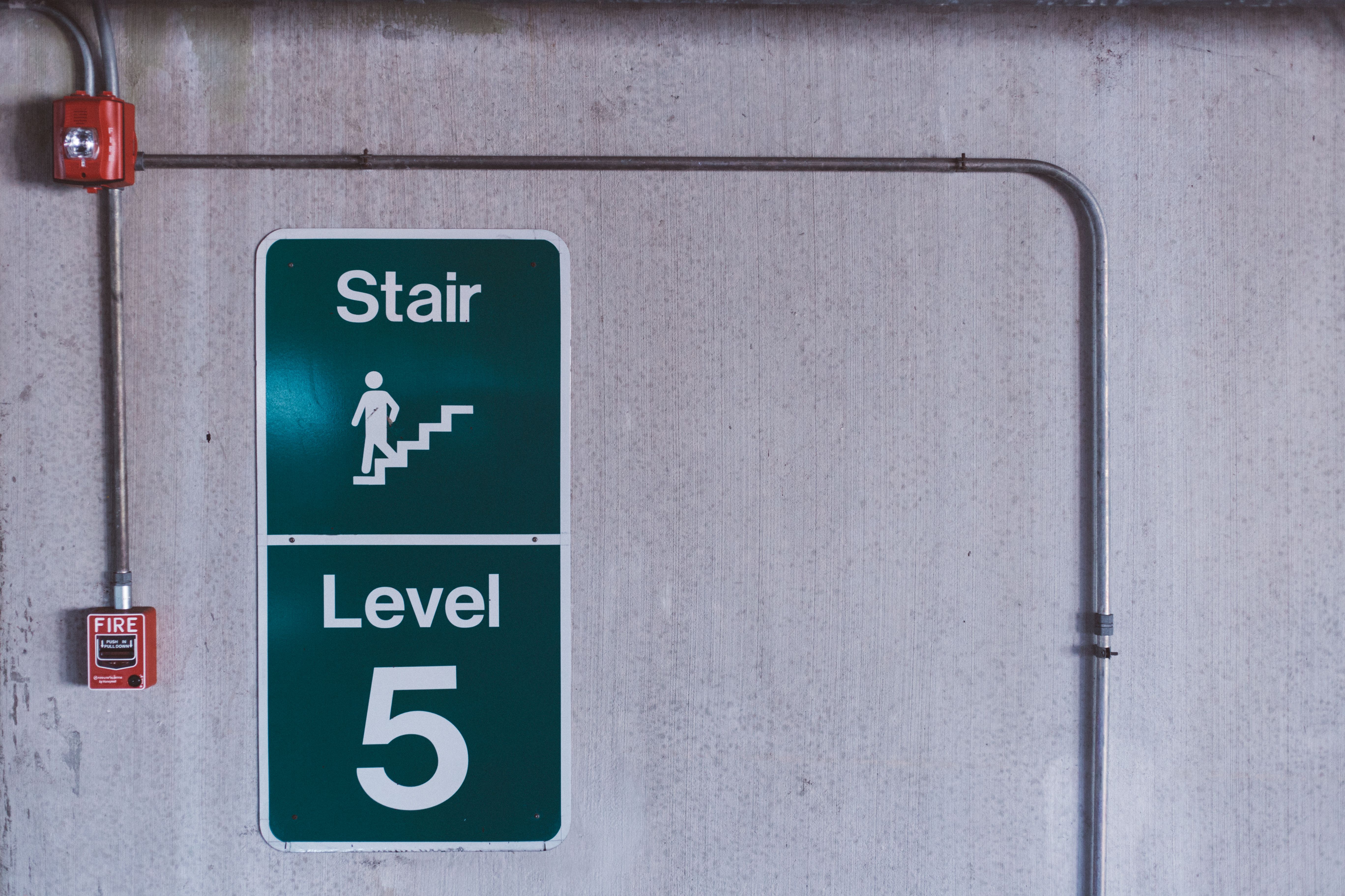 Fire alarm call point beside a stairwell sign