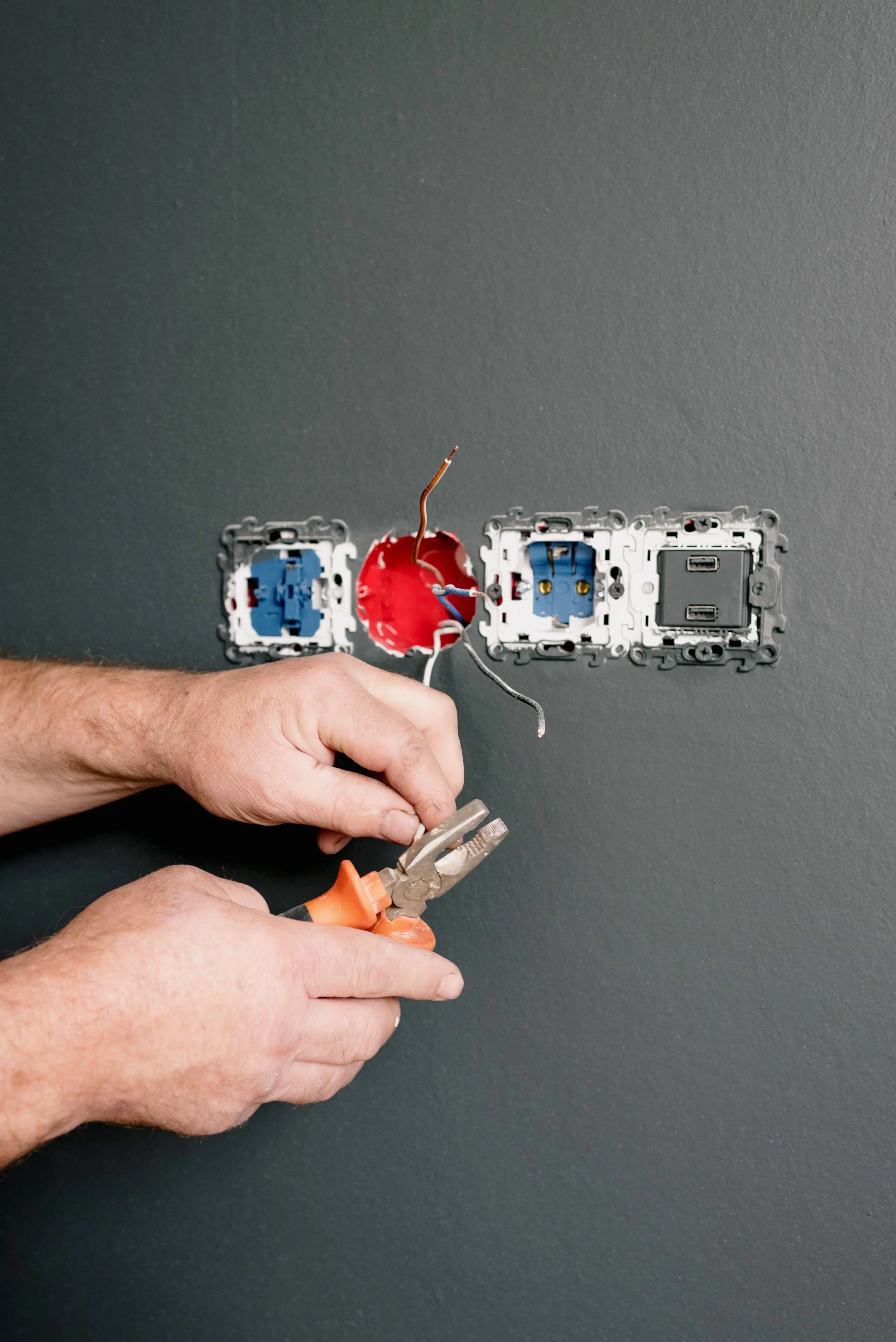 Electrician installing electrical wall sockets