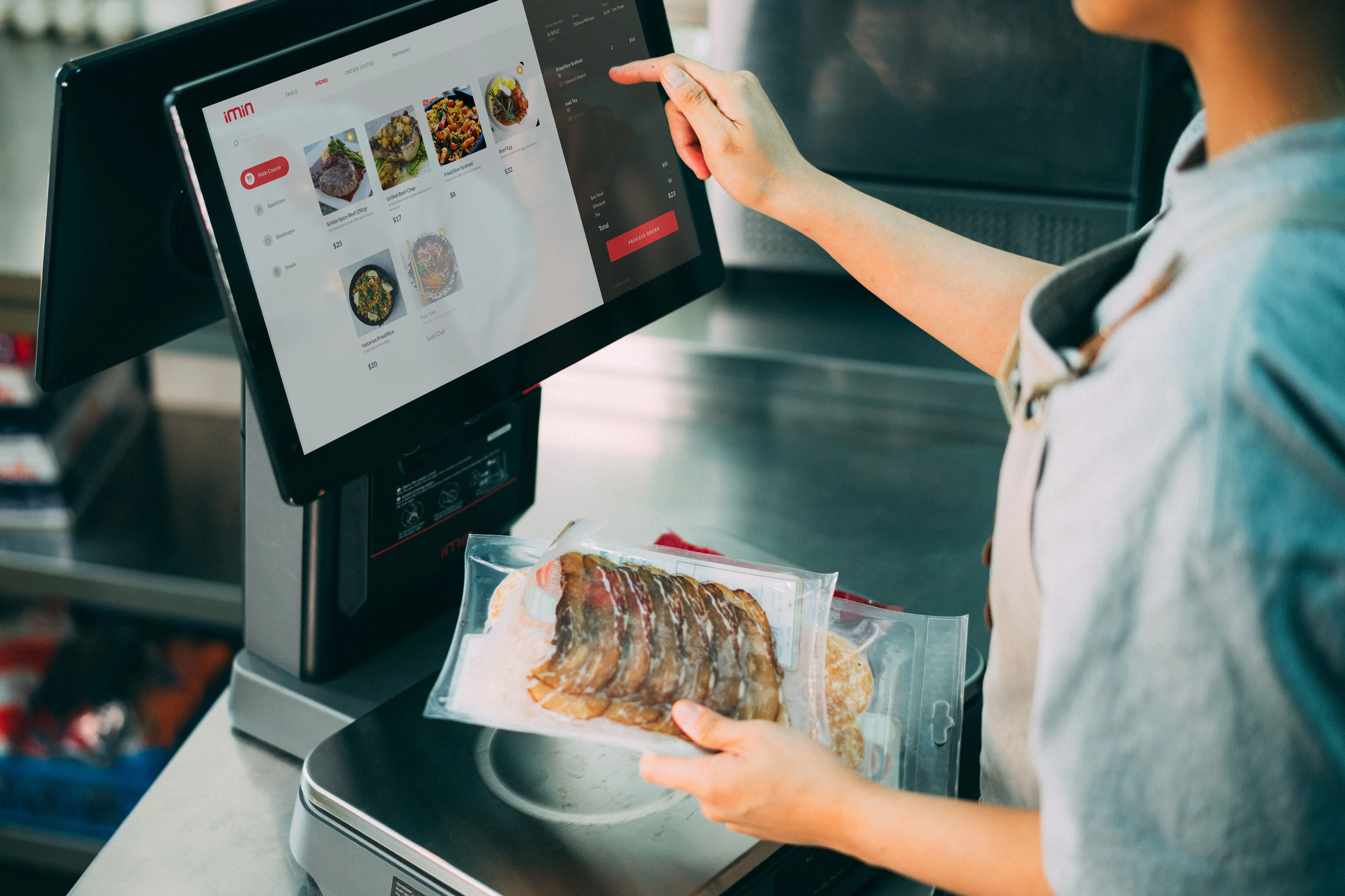 Staff using a touchscreen till in a cafe