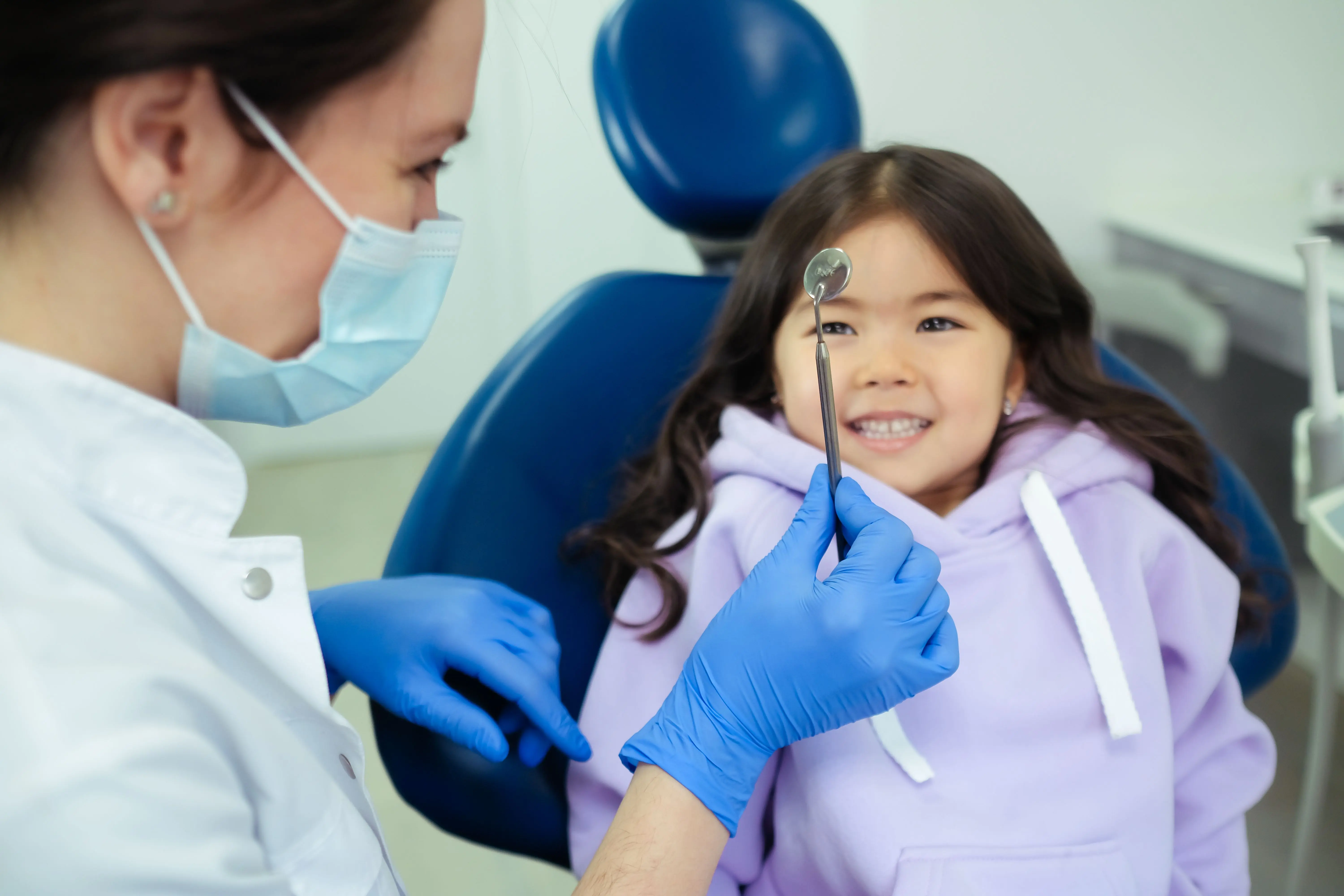 Dentist treating a patient in a bright surgery
