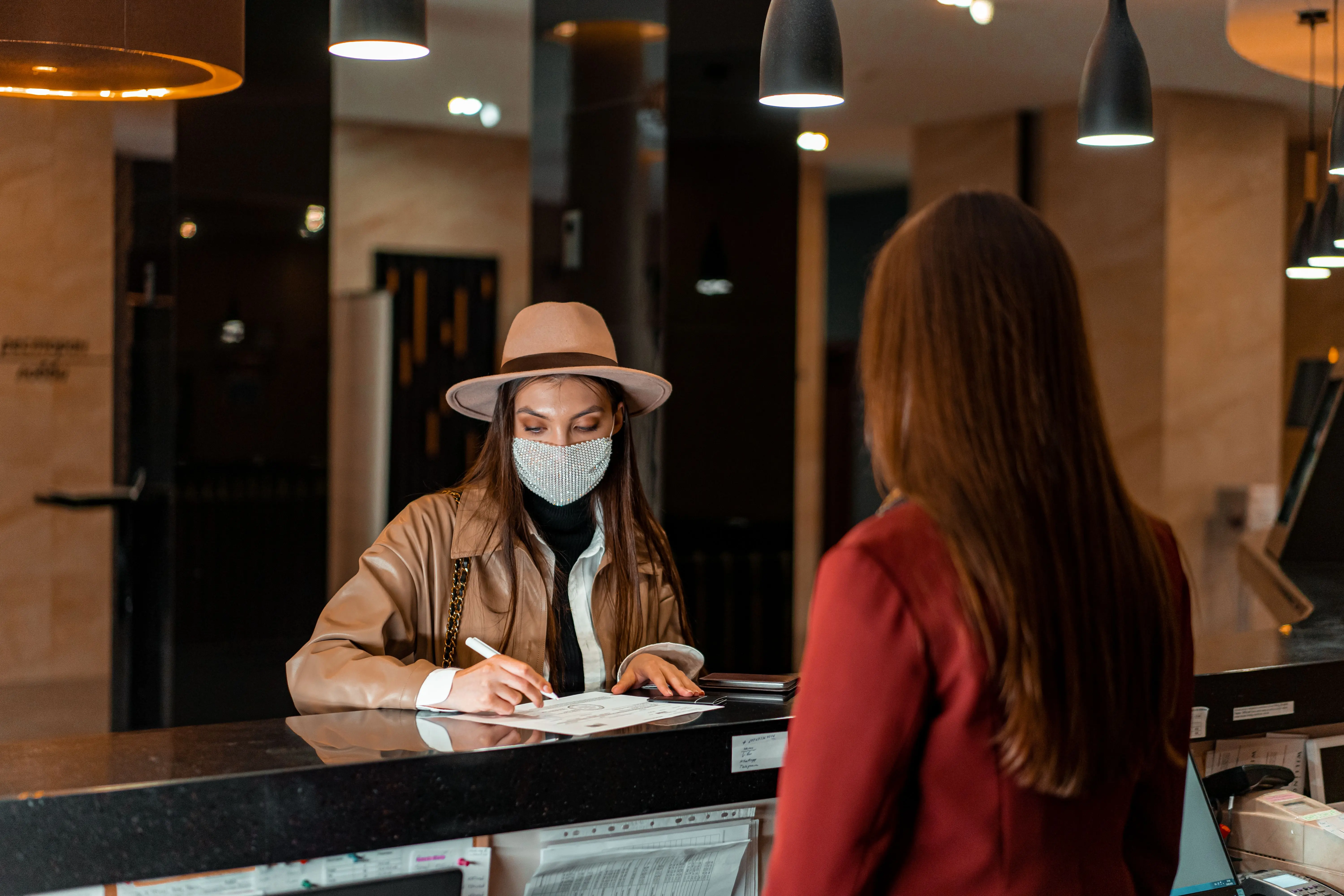 Guest checking in at a hotel reception desk